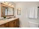 This bathroom has tile floors, a vanity with granite countertops, and natural light at 198 N Pecan Ct, Gilbert, AZ 85234