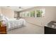 Bright bedroom with multiple windows, plush carpet, and a serene, neutral color palette at 198 N Pecan Ct, Gilbert, AZ 85234