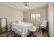 This bedroom has wood-look floors, a ceiling fan, and bright window at 198 N Pecan Ct, Gilbert, AZ 85234