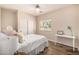 Cozy bedroom with wood-look floors, a ceiling fan, and natural light at 198 N Pecan Ct, Gilbert, AZ 85234