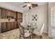 Cozy breakfast nook featuring wood cabinets, tile backsplash, and a glass table surrounded by four chairs at 198 N Pecan Ct, Gilbert, AZ 85234