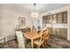 Formal dining room featuring custom cabinetry, hardwood floors, and stylish chandelier over the wooden dining table at 198 N Pecan Ct, Gilbert, AZ 85234