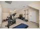 This exercise room features carpeted floors, a ceiling fan, and various fitness equipment at 198 N Pecan Ct, Gilbert, AZ 85234