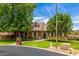 Well-maintained brick home with lush landscaping, a tidy front yard, and a welcoming entryway at 198 N Pecan Ct, Gilbert, AZ 85234