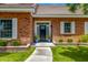 Close-up of a welcoming front entrance with a black door, potted plants, and neat landscaping at 198 N Pecan Ct, Gilbert, AZ 85234