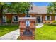 Charming brick home featuring lush green lawn and landscaping with a brick mailbox post at 198 N Pecan Ct, Gilbert, AZ 85234