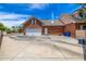 Spacious brick garage with a large driveway, providing ample parking and storage space at 198 N Pecan Ct, Gilbert, AZ 85234