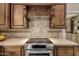 Modern kitchen featuring stainless steel appliances, quartz countertops, custom cabinets, and stylish backsplash at 198 N Pecan Ct, Gilbert, AZ 85234