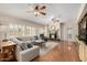 Bright living room features a fireplace, hardwood floors, ceiling fans, and natural light from the many windows at 198 N Pecan Ct, Gilbert, AZ 85234