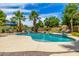 Gorgeous pool area with rock accents, lush palm trees, patio furniture, and a sparkling, refreshing pool at 198 N Pecan Ct, Gilbert, AZ 85234