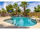 Inviting pool with a rock waterfall feature and lush landscaping, perfect for relaxing and entertaining outdoors at 198 N Pecan Ct, Gilbert, AZ 85234