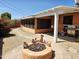 Outdoor patio area with pergola, grill, sun room and stone firepit with lush vegetation at 2027 N 81St St, Scottsdale, AZ 85257
