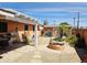 Outdoor patio with pergola and landscaped backyard featuring a stone fire pit, a shed and mature plantings at 2027 N 81St St, Scottsdale, AZ 85257