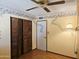 Cozy bedroom featuring a ceiling fan, floral wallpaper and double door closet at 2027 N 81St St, Scottsdale, AZ 85257
