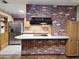 Modern kitchen featuring stainless steel appliances, ample countertop space, and brick accents for a cozy feel at 2027 N 81St St, Scottsdale, AZ 85257