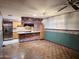 Open-concept living space, featuring hardwood floors, brick wall kitchen, and a stainless steel refrigerator at 2027 N 81St St, Scottsdale, AZ 85257