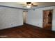 View of a living room featuring hardwood floors, ceiling fan, and archway into a kitchen at 2027 N 81St St, Scottsdale, AZ 85257