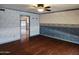 View of a living room featuring hardwood floors, ceiling fan, and archway into a kitchen at 2027 N 81St St, Scottsdale, AZ 85257