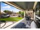 Enjoyable backyard with a covered patio, outdoor kitchen, lounging area and a synthetic grass lawn at 2105 E San Carlos Pl, Chandler, AZ 85249