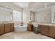 A bright bathroom with a soaking tub, dual sinks, and a vanity area offers a spa-like experience at home at 2105 E San Carlos Pl, Chandler, AZ 85249