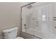 Bathroom showcasing a shower and tub combination behind glass, as well as a toilet at 2105 E San Carlos Pl, Chandler, AZ 85249