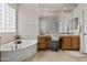 This bathroom features a luxurious soaking tub, a spacious vanity area, and a glass-enclosed shower for a spa-like retreat at 2105 E San Carlos Pl, Chandler, AZ 85249