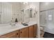 Bathroom featuring a double sink vanity, large mirrors, and a shower with glass door at 2105 E San Carlos Pl, Chandler, AZ 85249