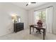 Bedroom with a dark wood desk, neutral walls, bright window, and a comfortable chair at 2105 E San Carlos Pl, Chandler, AZ 85249