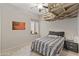Cozy bedroom featuring a ceiling fan, a unique raised platform, and a queen-sized bed at 2105 E San Carlos Pl, Chandler, AZ 85249