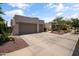 Charming home with a three-car garage, beautiful desert landscaping, and a spacious driveway at 2105 E San Carlos Pl, Chandler, AZ 85249