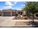Beautiful home with a three-car garage, desert landscaping, and a charming entrance at 2105 E San Carlos Pl, Chandler, AZ 85249