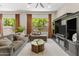 Relaxing living room with plush seating, TV, and large windows offering natural light and outdoor views at 2105 E San Carlos Pl, Chandler, AZ 85249