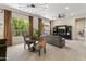 Bright living room featuring stylish seating, modern light fixture, and large windows with verdant views at 2105 E San Carlos Pl, Chandler, AZ 85249