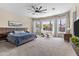 Spacious main bedroom boasts large windows, a ceiling fan, and a comfortable seating area at 2105 E San Carlos Pl, Chandler, AZ 85249