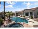 Backyard oasis featuring a sparkling pool, spa with rock accents, and covered patio at 2105 E San Carlos Pl, Chandler, AZ 85249