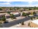 Neighborhood street view of a well-maintained home featuring desert landscaping, mature trees, and convenient two-car garage at 2105 E San Carlos Pl, Chandler, AZ 85249