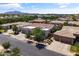 Neighborhood street view of a well-maintained home with a desert-landscaped front yard, mature trees, and a two-car garage at 2105 E San Carlos Pl, Chandler, AZ 85249