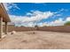 View of the home's backyard, featuring a brick wall and plenty of space at 21610 N Bradford Dr, Maricopa, AZ 85138