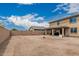 The home's spacious backyard features a block wall, perfect for pets or other activities at 21610 N Bradford Dr, Maricopa, AZ 85138