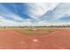 Baseball field with well-groomed playing surface and manicured infield, perfect for sports enthusiasts and community games at 21610 N Bradford Dr, Maricopa, AZ 85138