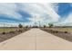 Well-maintained baseball field with fenced perimeter, lighting, and spectator seating for community sports and events at 21610 N Bradford Dr, Maricopa, AZ 85138