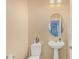 Powder room with pedestal sink, decorative mirror, and neutral paint at 21610 N Bradford Dr, Maricopa, AZ 85138