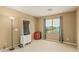 Bedroom features a window with curtains, neutral carpet and a wardrobe/storage unit at 21610 N Bradford Dr, Maricopa, AZ 85138