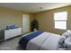 Stylish bedroom with a comfortable bed, window and white dresser at 21610 N Bradford Dr, Maricopa, AZ 85138