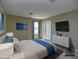 Comfortable bedroom featuring a large window, neutral walls, and stylish furnishings at 21610 N Bradford Dr, Maricopa, AZ 85138