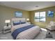 Bright bedroom featuring a large window, neutral walls, and stylish furnishings at 21610 N Bradford Dr, Maricopa, AZ 85138