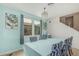 Bright dining room features blue accent wall, table, chandelier, and neutral tile at 21610 N Bradford Dr, Maricopa, AZ 85138