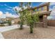 Low-maintenance landscaping in front of a charming two-story home with neutral color palette at 21610 N Bradford Dr, Maricopa, AZ 85138
