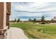 Expansive community green space with mature trees, landscaping, and walking paths for residents to enjoy outdoor activities at 21610 N Bradford Dr, Maricopa, AZ 85138