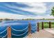 Expansive lake view showcasing waterfront homes, tranquil water, and chain railing at 21610 N Bradford Dr, Maricopa, AZ 85138
